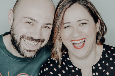 Close-up portrait of cheerful couple