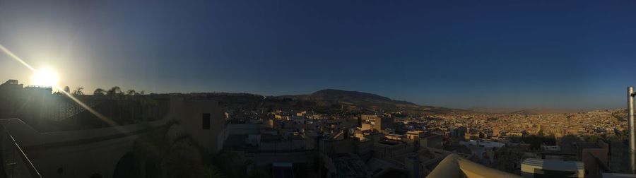 Panoramic view of town against sky during sunset