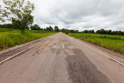 Road passing through landscape against sky