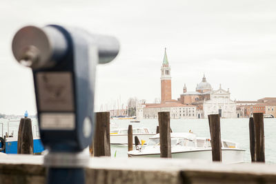 Close-up of cityscape against sea