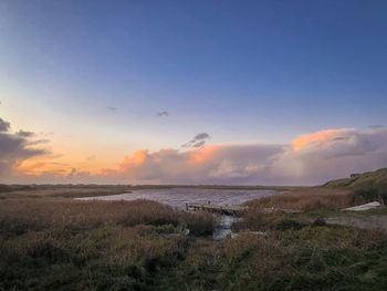 Scenic view of lake against sky during sunset