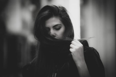 Portrait of young woman holding camera