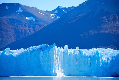 Glaciers melting against mountains during winter