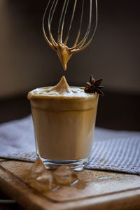 A glass of the popular trendy drink dalgona coffee with milk. whisk and ice. high quality photo