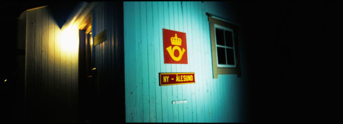 Information sign on wall at night