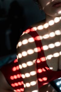 Close-up of woman with illuminated lighting equipment