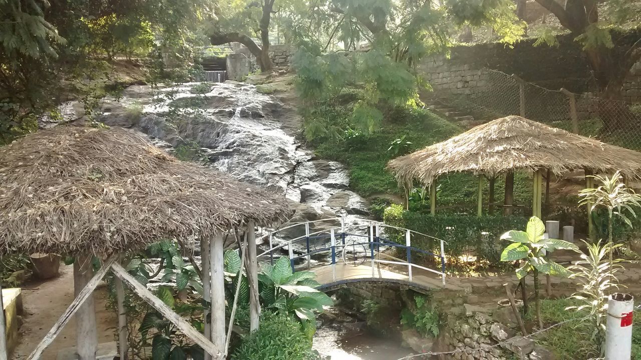 water, built structure, tree, architecture, plant, nature, connection, growth, bridge - man made structure, river, beauty in nature, tranquility, rock - object, no people, day, flowing water, outdoors, scenics, high angle view, railing