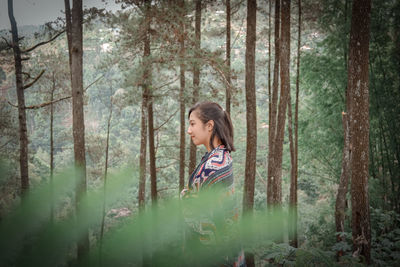 Side view of woman in forest