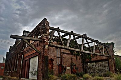 Low angle view of built structure against cloudy sky