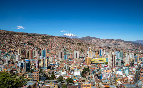 High angle view of townscape against blue sky