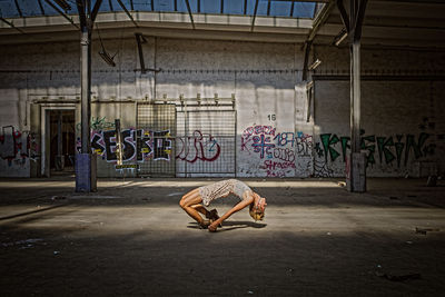 Man with graffiti on wall