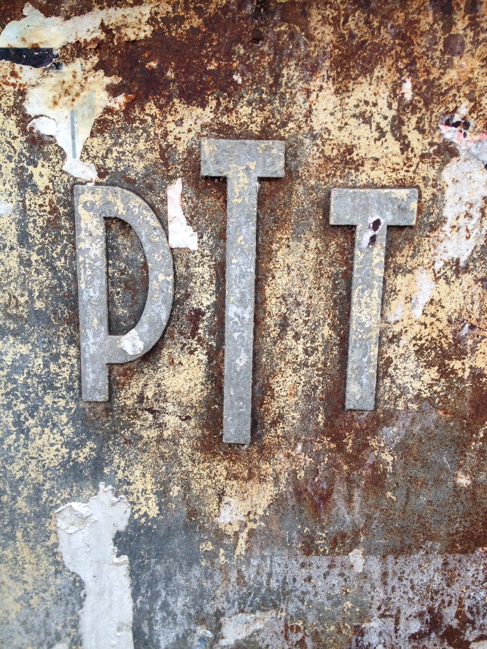 text, communication, western script, wall - building feature, close-up, built structure, guidance, sign, metal, capital letter, day, information sign, outdoors, wall, architecture, no people, textured, weathered, number, arrow symbol