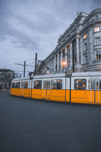 Train on street in city against sky