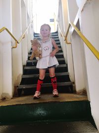 Portrait of girl standing on steps