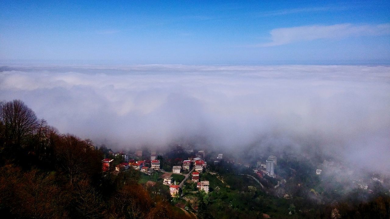 sky, scenics, beauty in nature, landscape, mountain, tranquil scene, nature, tranquility, high angle view, tree, cloud - sky, building exterior, weather, fog, built structure, outdoors, growth, cityscape, architecture, dusk