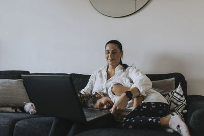 Mother and daughter on sofa