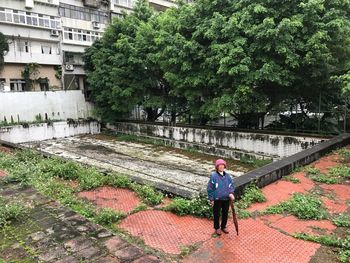 Full length of man with umbrella on tree