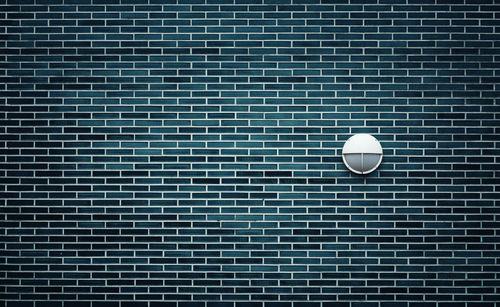 Brickwall with a single lamp.