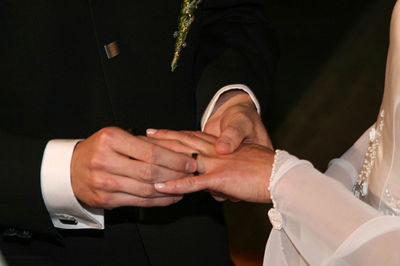 Midsection of couple holding hands