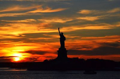 Silhouette of statue at sunset