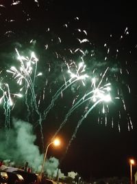 Low angle view of firework display at night