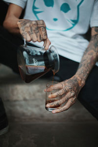 Close-up of man pour coffee