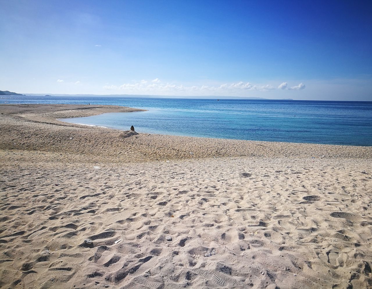 beach, sand, sea, horizon over water, nature, sky, beauty in nature, scenics, water, tranquility, tranquil scene, blue, one person, day, outdoors, vacations, real people, people