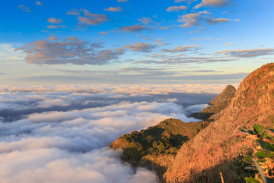 Scenic view of mountains against cloudy sky