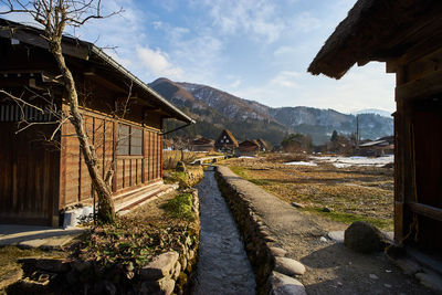 Scenic view of village houses against cloudy sky