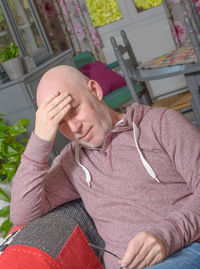 Mature man relaxing on sofa at home