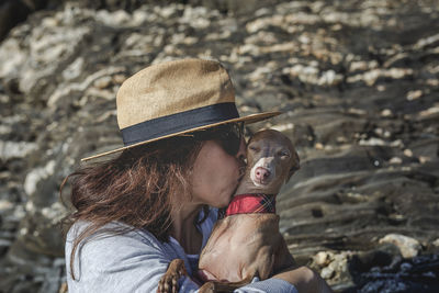 Mature woman with dog at beach