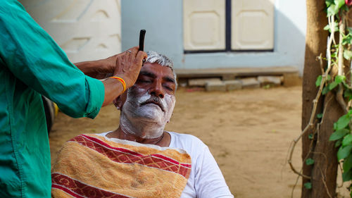 Portrait of man sitting outdoors