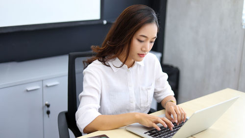 Young woman using laptop at home