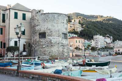 Boats by building at beach