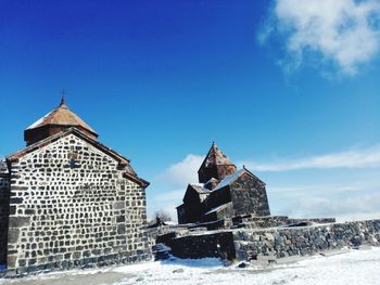 Built structures against blue sky during winter