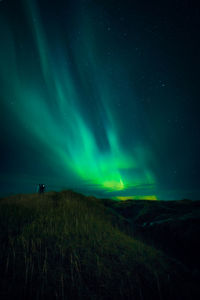 Scenic view of land against sky at night