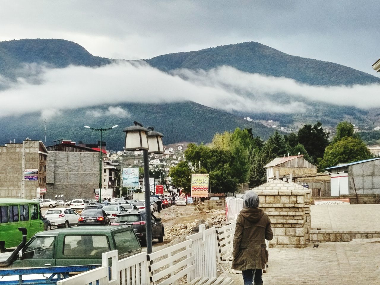 mountain, built structure, building exterior, architecture, real people, sky, day, one person, rear view, outdoors, mountain range, nature, beauty in nature, people