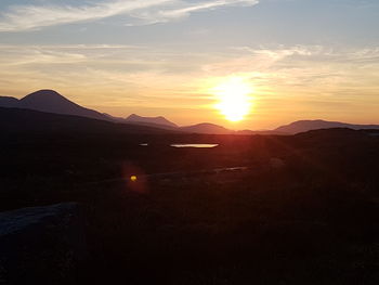 Scenic view of silhouette mountains against sky during sunset