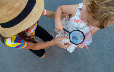 High angle view of girl playing with friend