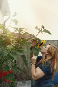 Woman standing by flower tree