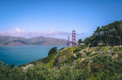 Scenic view of bay against blue sky