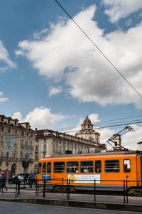 Railroad track against cloudy sky
