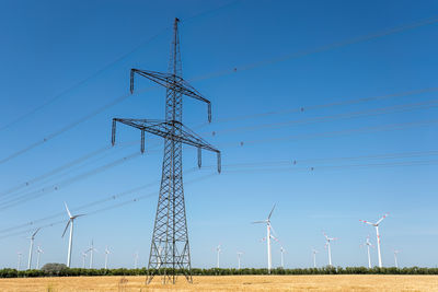 Low angle view of electricity pylon against sky