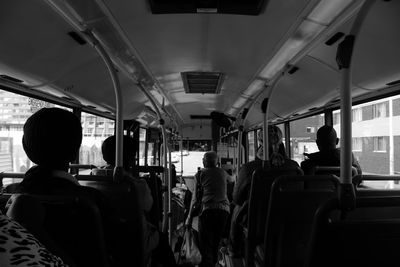 Rear view of people sitting in train