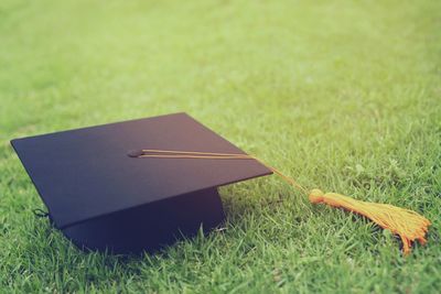 Shot of graduation hat on the grass, concept during commencement success graduates of the university