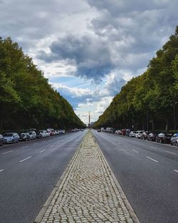 Road by trees against sky