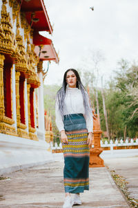 Woman standing against building