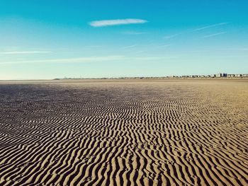 Scenic view of desert against blue sky