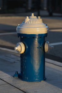 Close-up of fire hydrant on footpath