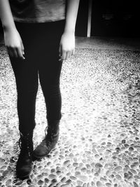 Low section of woman standing on tiled floor